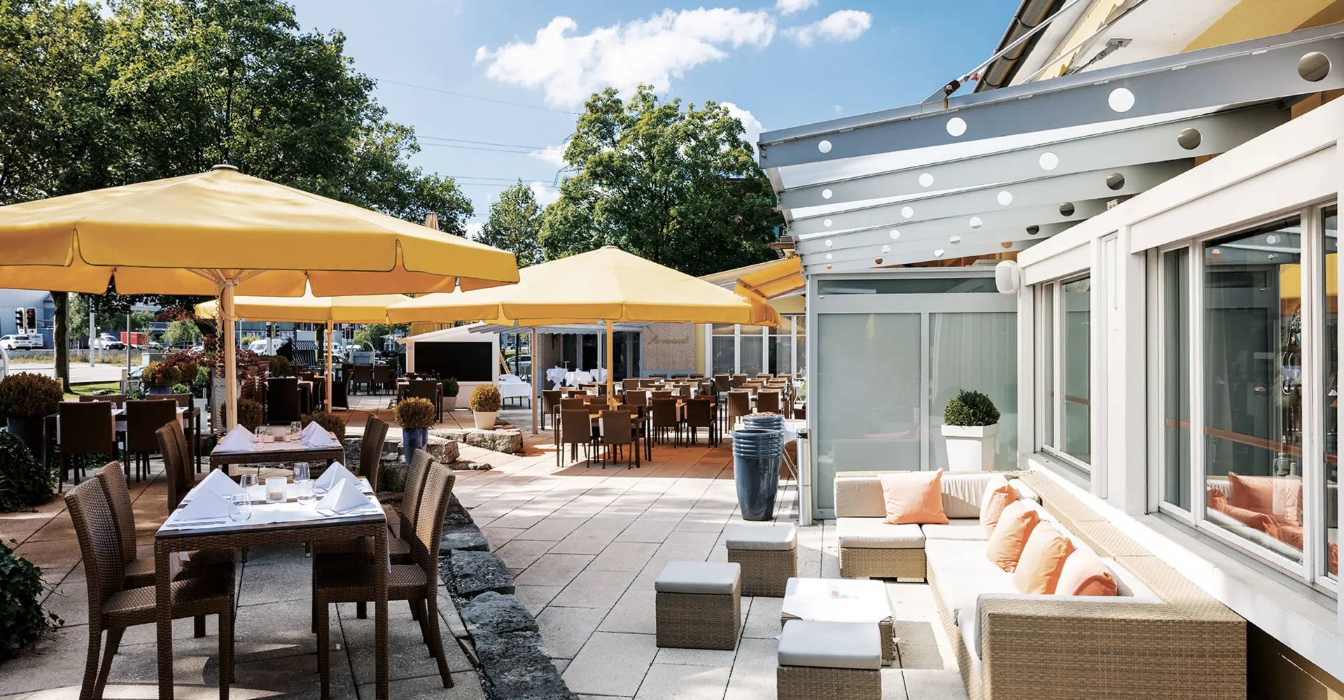 the terrace with tables and umbrellas at the Hotel Sonnental