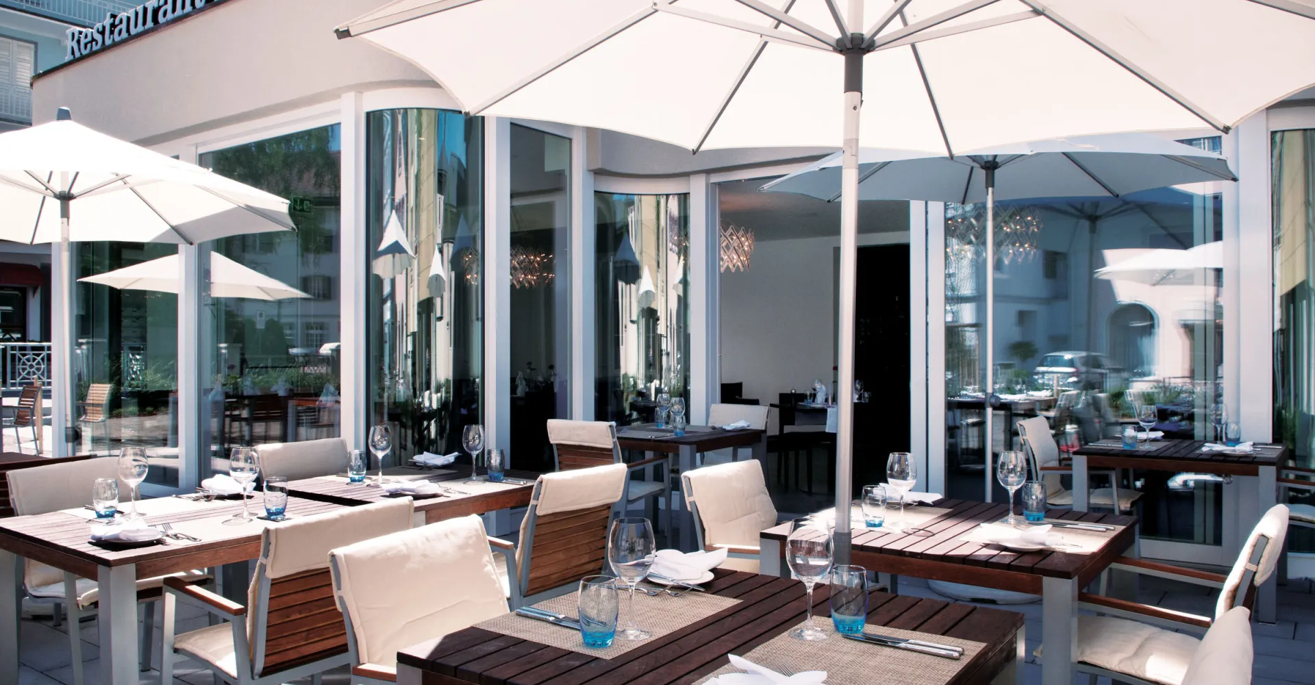 Outdoor area with tables, chairs and summer umbrella in the Tamina