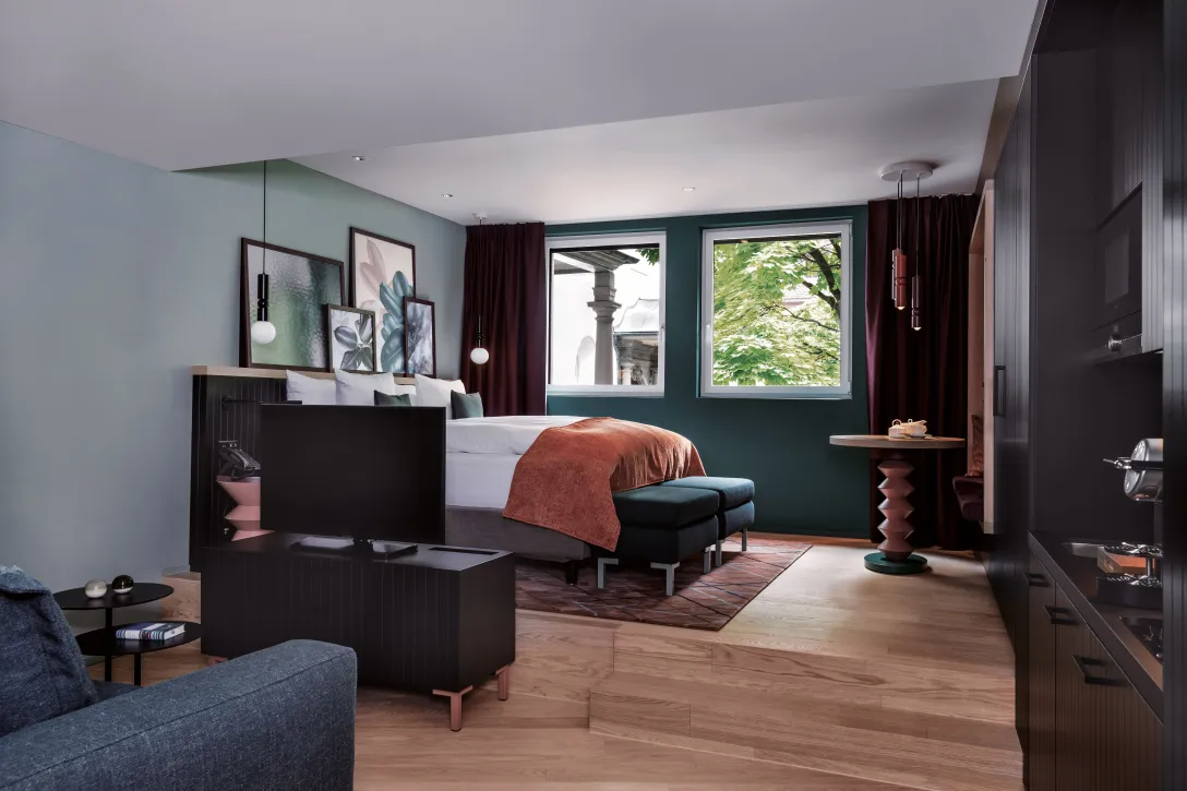 Sorell Hotel St. Peter Grand Deluxe Room with seating area and TV