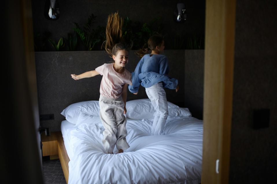 Kinder hüpfen auf dem Bett
