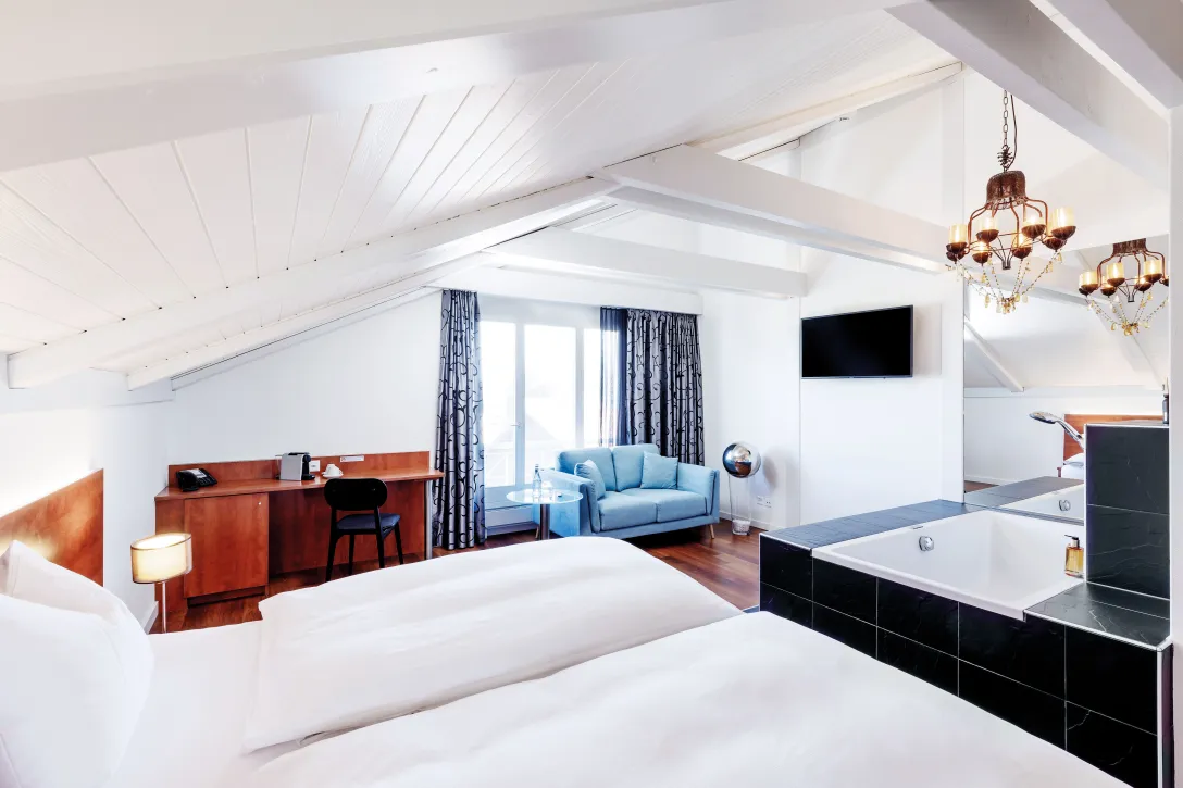 Sorell Hotel Sonnental Double room with whirlpool and seating area