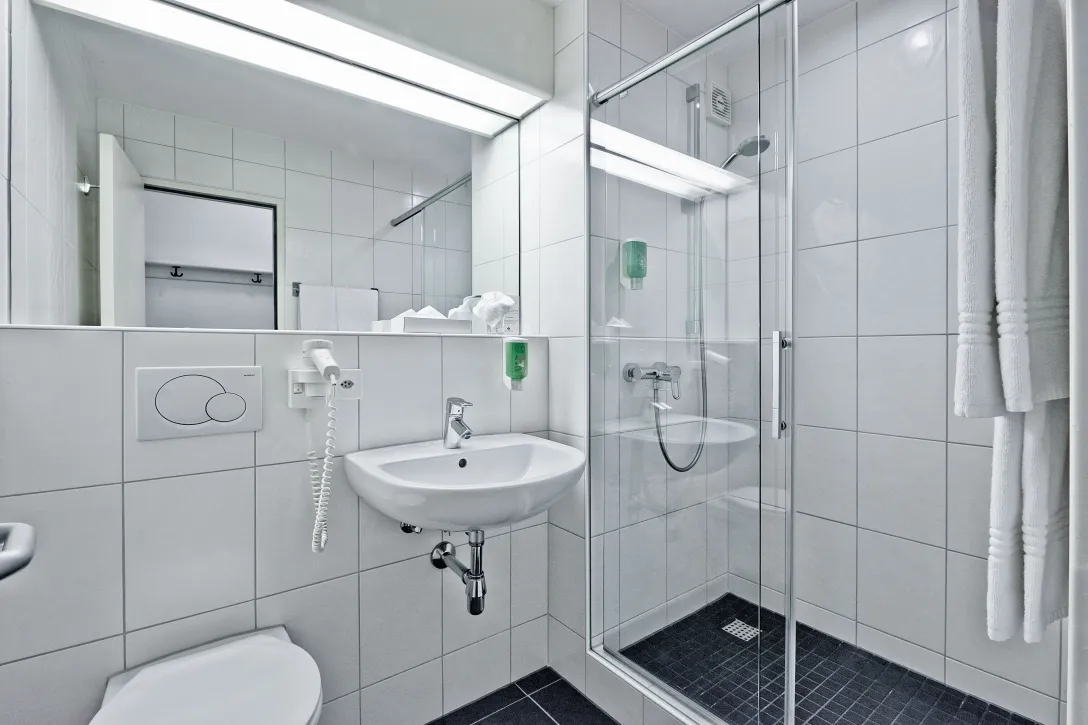 Sorell Hotel Sonnental Standard Triple Room Bathroom with shower