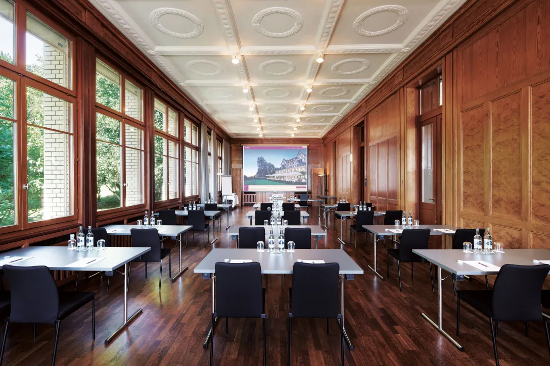 Kursaal 1 with tables and chairs at the Hotel Zürichberg