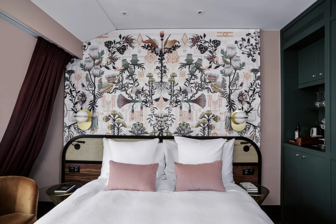 Room with pink cushions and pattern on the wall at Hotel Seidenhof