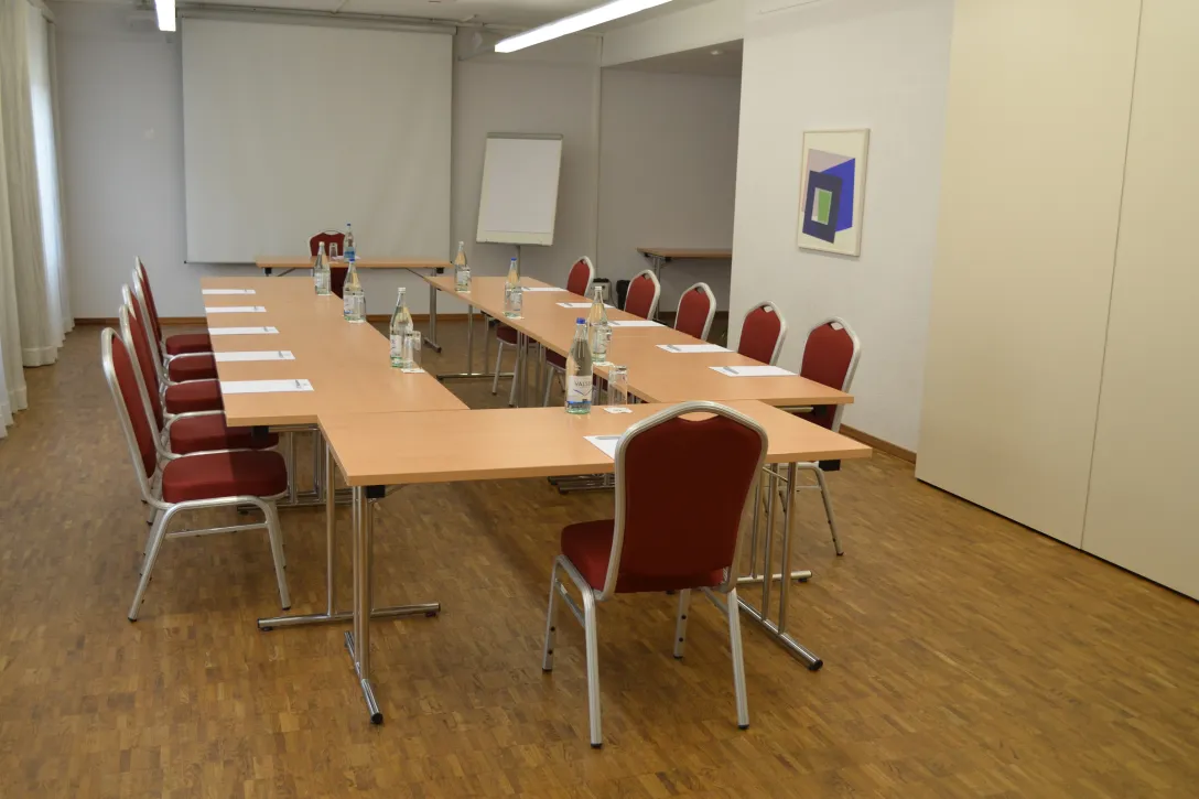 Hotel Tamina meeting room with tables and chairs including screen