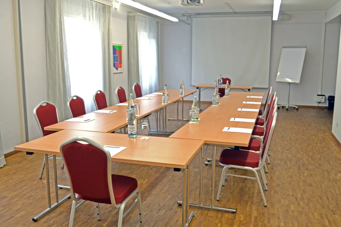 Hotel Tamina meeting room with tables and chairs including screen
