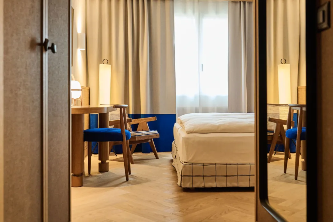 Hotel room entrance with a view of the bed