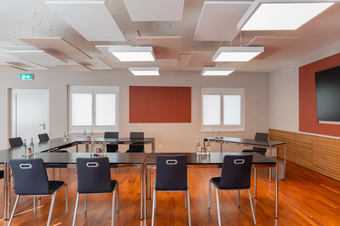 Meeting room with U-shaped chair and TV on the wall