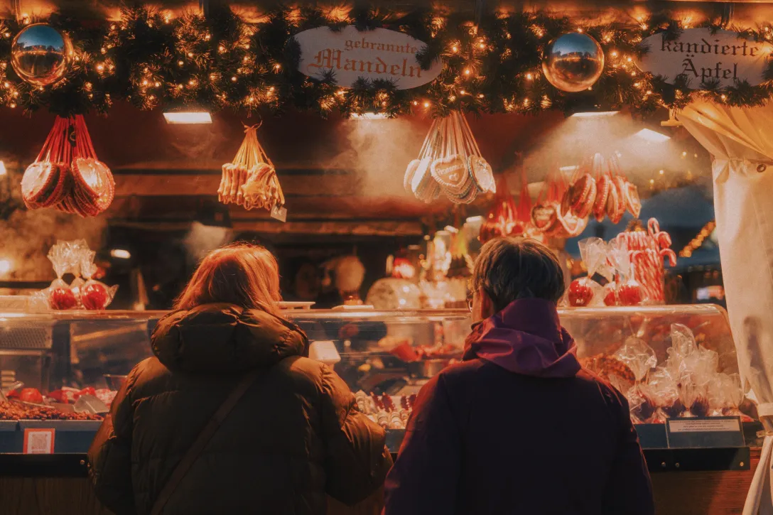 People in front of a stall at the Christmas market