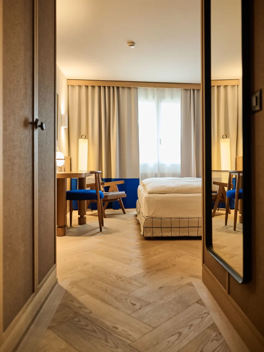 Hotel room entrance with a view of the bed