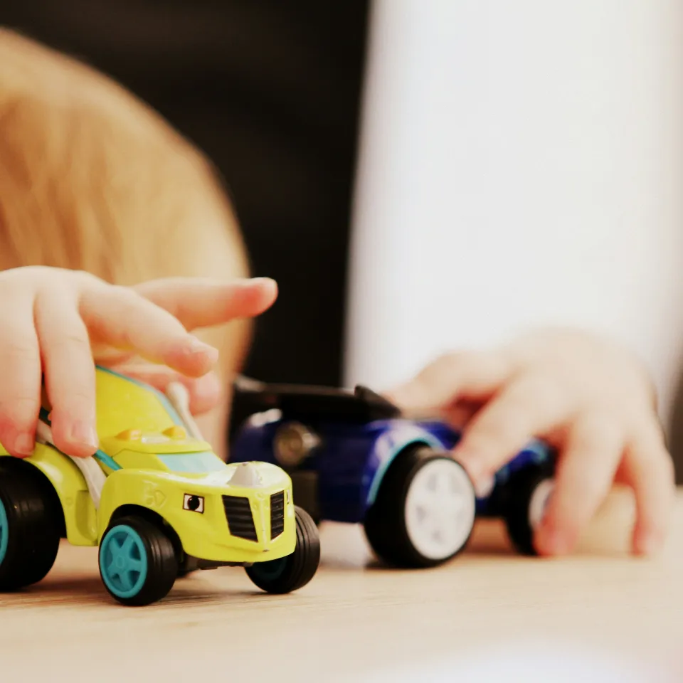 Child playing with cars