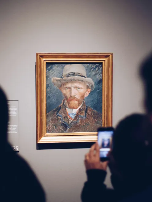 Person takes a picture of a painting