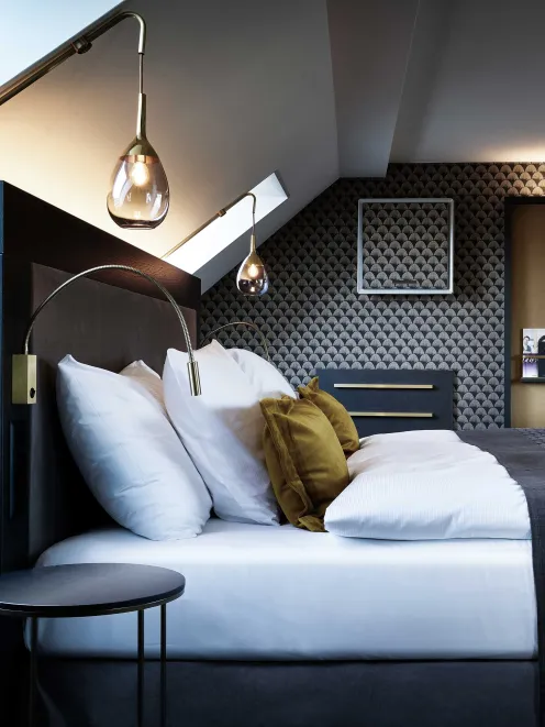 Bed in a deluxe double room at Hotel Seefeld