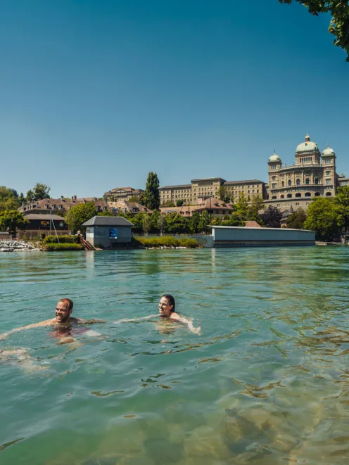 three people swimming in the Aara