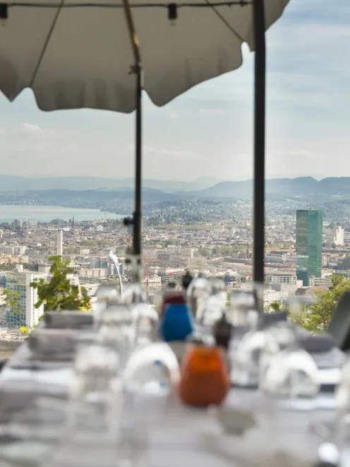 Exterior shot of a restaurant with a view of Zurich