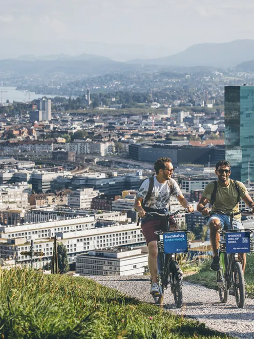 Two people cycling in Zurich